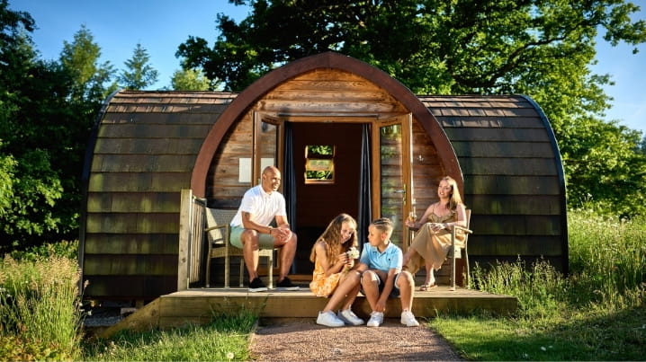 Family sitting out a Whitemead glamping pod
